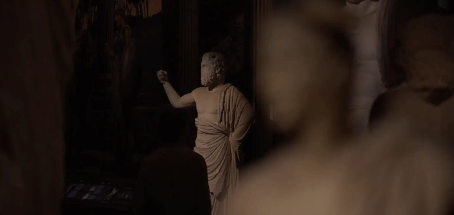 Museum visitors exploring classical sculptures